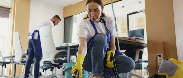 professional-cleaning-service-person-using-vacuum-cleaner-office